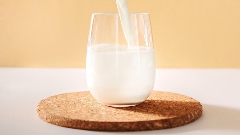 milk being poured into glass