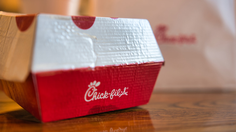 closed chick-fil-a sandwich container on table