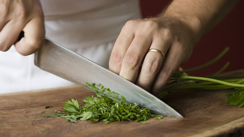 chopping herb with knife