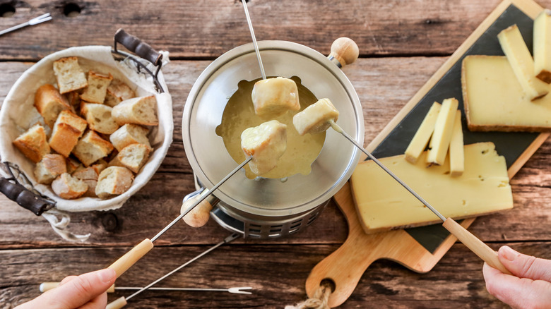 fondue cheese in pot with skewers