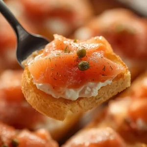 smoked-salmon-crostini: Golden crostini slices layered with cream cheese and pink smoked salmon, garnished with fresh dill for a quick appetizer.