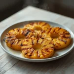 brazilian grilled pineapple: : Grilled pineapple slices with caramelized marks and cinnamon topping