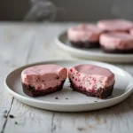 raspberry cheesecake bites: : Raspberry cheesecake bites with chocolate crust on a plate