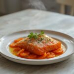 A plated serving of spicy salmon crudo with carrots, featuring bright colors and crispy textures for a fresh appetizer.