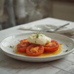 Platter of roasted tomatoes with burrata, showing golden tomatoes and creamy white cheese