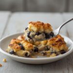 Golden baked blueberry french toast casserole in a baking dish, ready to serve for breakfast.