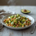 A vibrant bowl of chickpea feta avocado salad with colorful vegetables and creamy avocado, ready to serve.