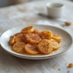 Cinnamon-sugar air fryer banana chips in a bowl, golden and crispy, perfect for snacking.