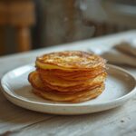 Golden crispy potato stacks with buttery layers on a plate, a perfect savory side dish