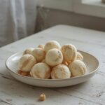 A plate of frozen Greek yogurt peanut butter bites, showing their creamy texture and round shape, perfect for a healthy snack.
