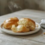 Korean cream cheese garlic buns on a table, golden brown and freshly baked.