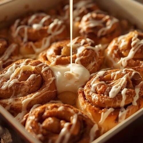 Delicious Cinnamon Rolls with Apple Pie Filling baked in a dish, featuring golden brown cinnamon roll pieces and warm apple filling, perfect for dessert.